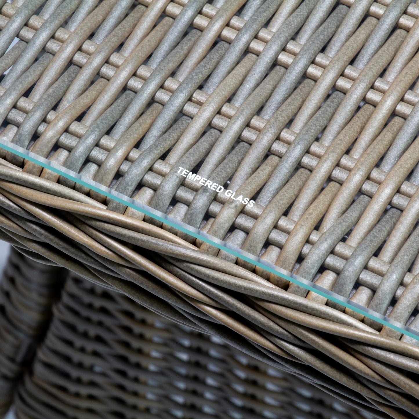 Close-up of outdoor poly rattan wicker table with tempered glass top, natural brown finish