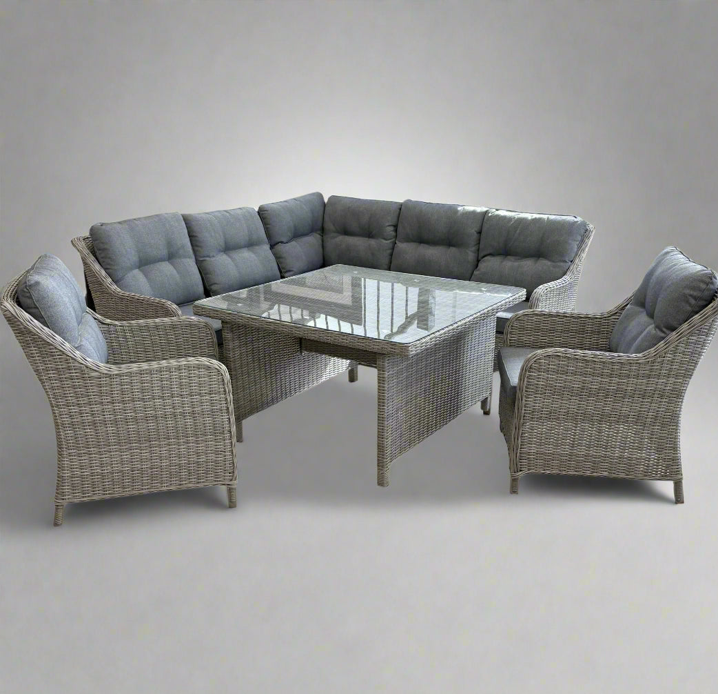 Outdoor patio furniture lounge dining set with a sectional sofa and glass table on a white background