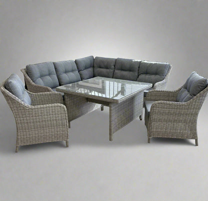 Outdoor patio furniture lounge dining set with a sectional sofa and glass table on a white background